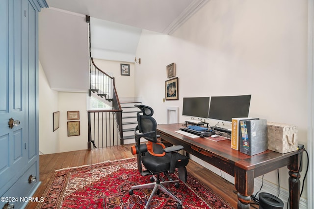 office space featuring wood-type flooring and crown molding