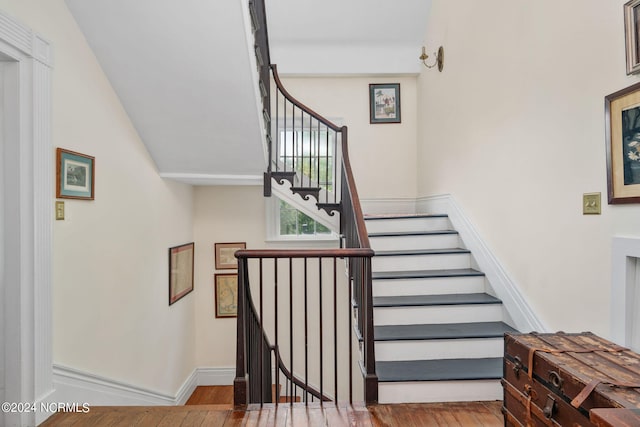 stairs featuring hardwood / wood-style flooring