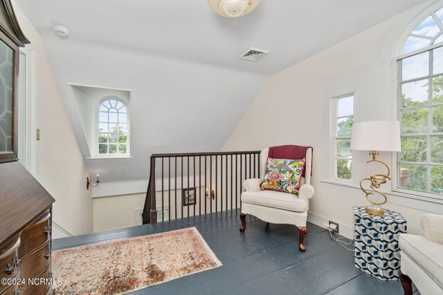 sitting room featuring vaulted ceiling