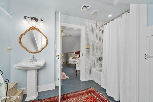 bathroom featuring tile patterned floors, shower / bath combo, and sink