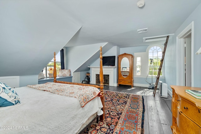 bedroom featuring hardwood / wood-style flooring and lofted ceiling