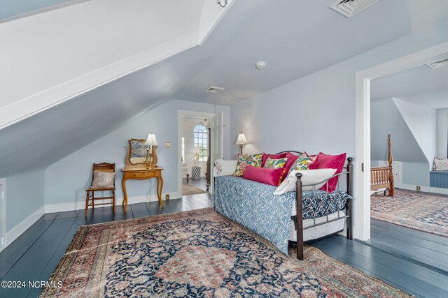 bedroom featuring wood-type flooring and lofted ceiling