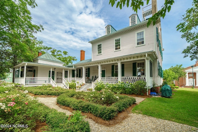 exterior space with a porch and a front lawn