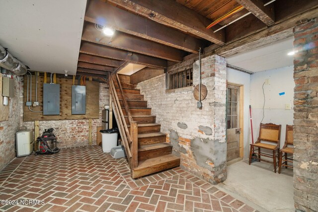 basement featuring brick wall and electric panel