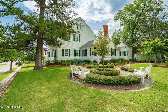 rear view of house with a lawn