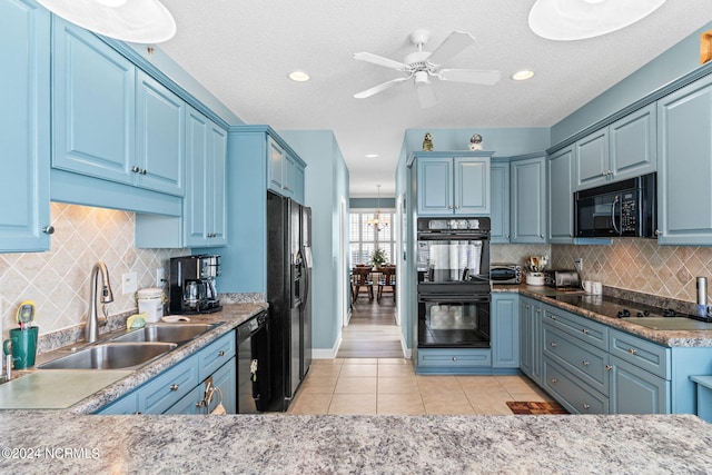 kitchen with sink, decorative backsplash, light tile patterned floors, black appliances, and blue cabinetry