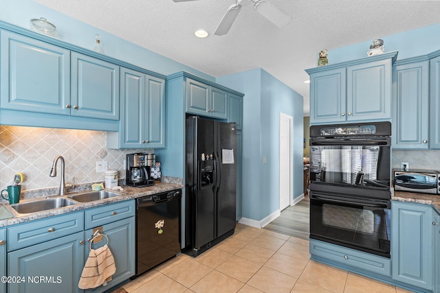 kitchen featuring sink, light tile patterned floors, backsplash, black appliances, and blue cabinets