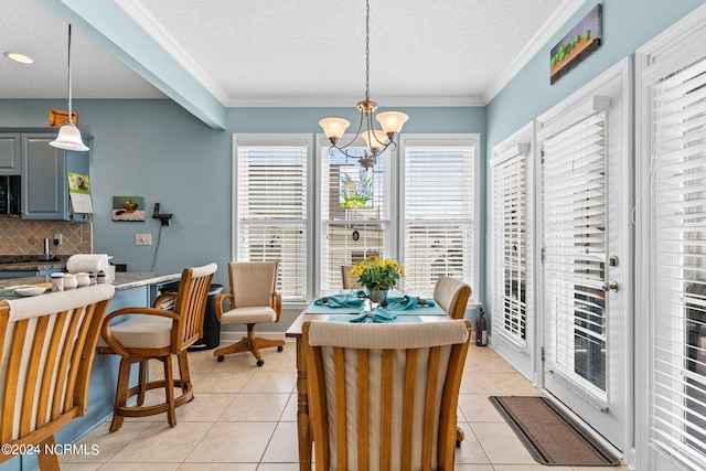 dining room featuring ornamental molding, a chandelier, a textured ceiling, and light tile patterned flooring