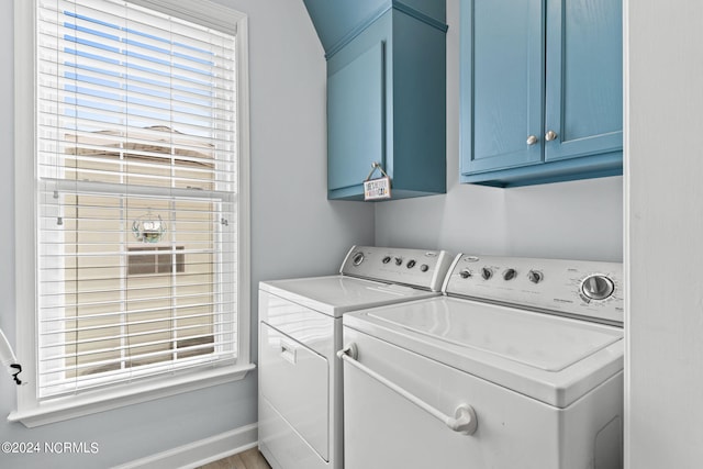 laundry area featuring cabinets, separate washer and dryer, and a wealth of natural light