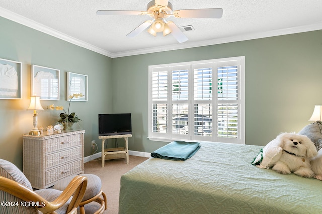 carpeted bedroom with ornamental molding, ceiling fan, and a textured ceiling