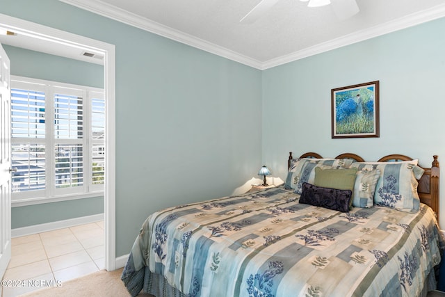 bedroom with light tile patterned floors, crown molding, and ceiling fan