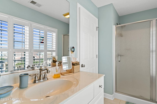 bathroom featuring walk in shower, tile patterned floors, and vanity