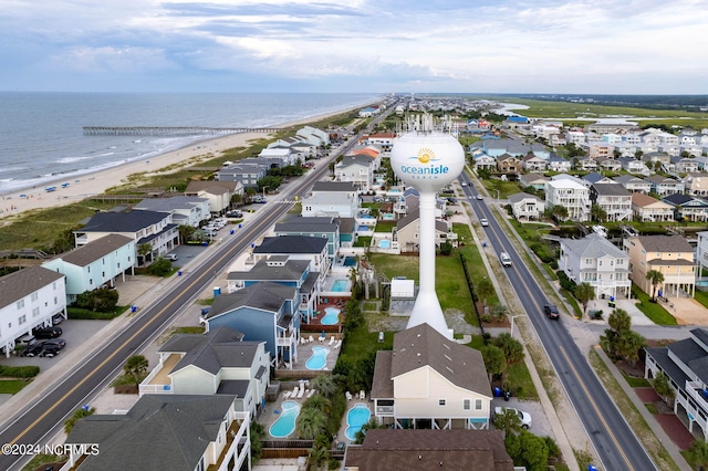 birds eye view of property featuring a water view and a view of the beach