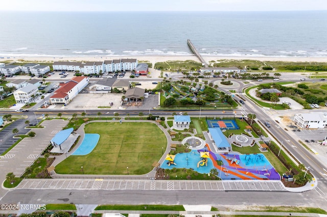 aerial view with a water view and a beach view