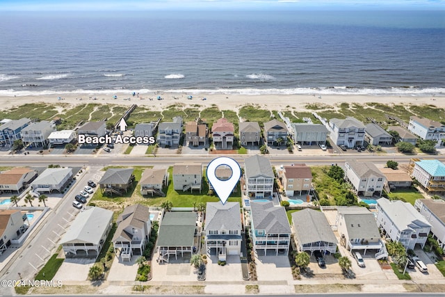 drone / aerial view featuring a water view and a view of the beach