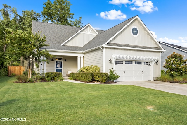 view of front of home with roof with shingles, concrete driveway, an attached garage, fence, and a front lawn