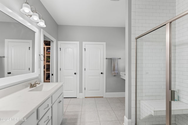 bathroom featuring vanity, tile patterned floors, and walk in shower