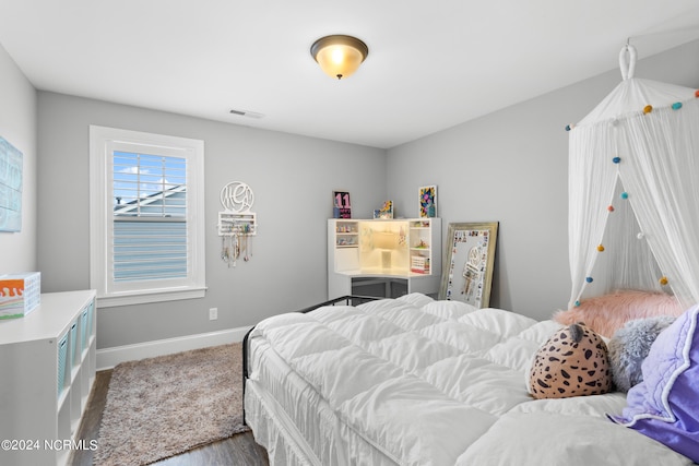 bedroom with hardwood / wood-style floors