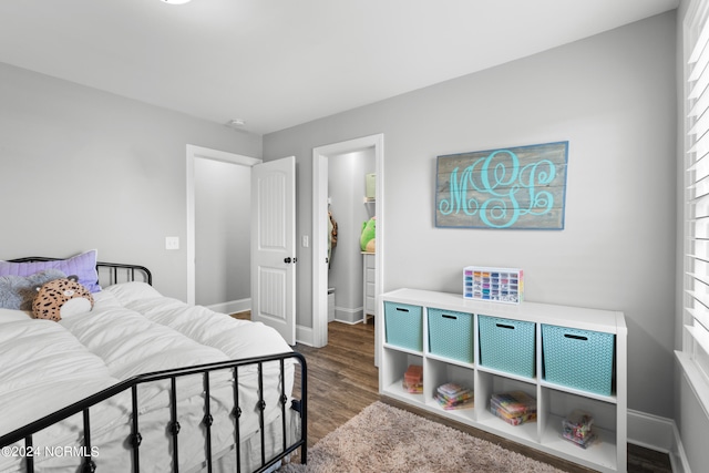 bedroom with dark hardwood / wood-style floors