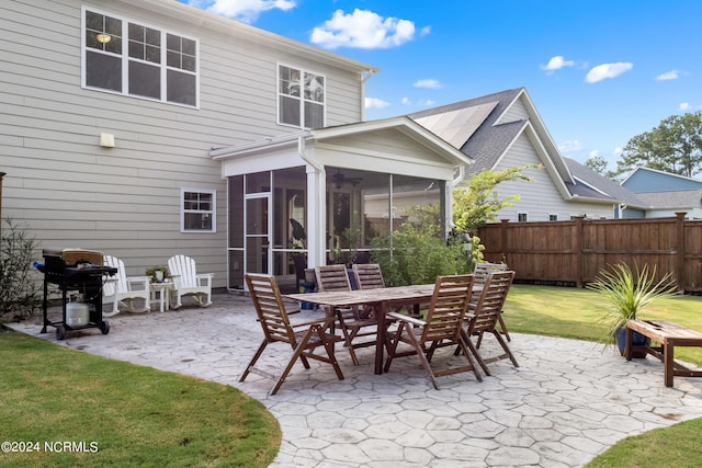 view of patio / terrace featuring area for grilling and a sunroom