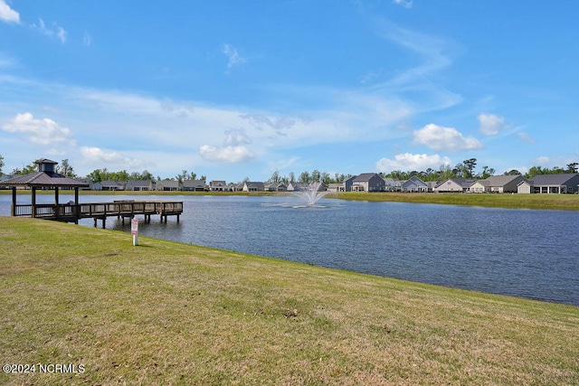 dock area featuring a gazebo, a yard, and a water view