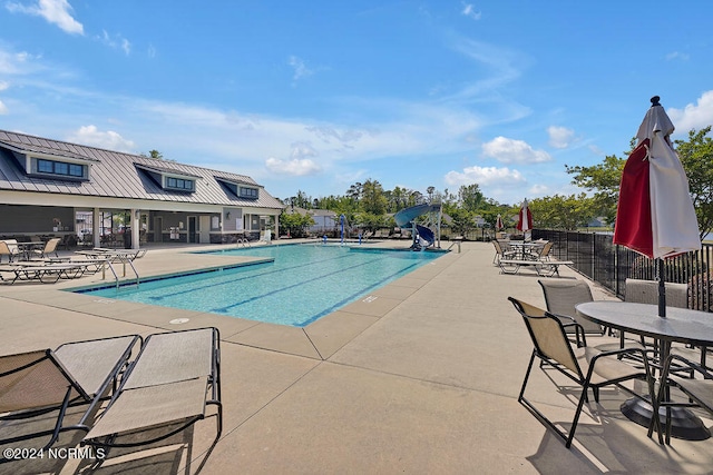 view of pool with a patio and a water slide