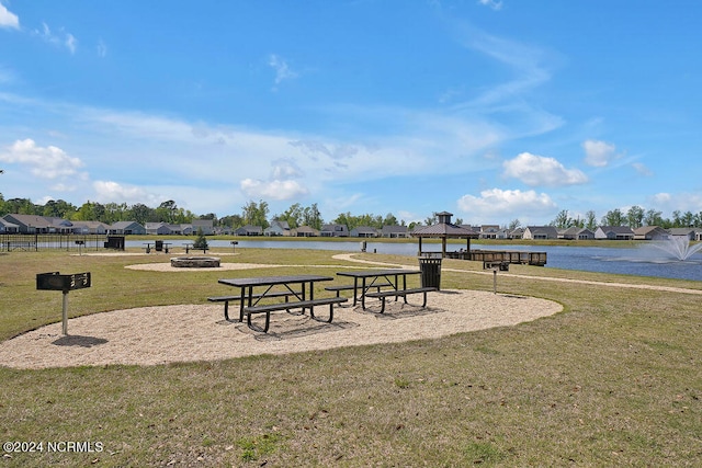 view of home's community featuring a gazebo, a fire pit, a water view, and a yard