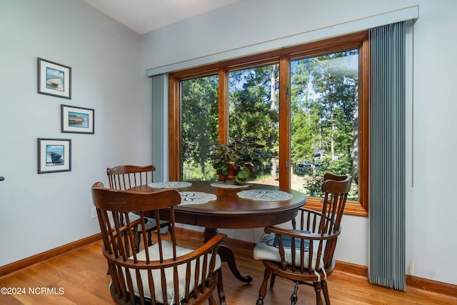dining room featuring baseboards and light wood-type flooring