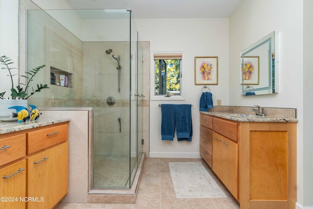 bathroom featuring vanity, tile patterned floors, and a shower stall