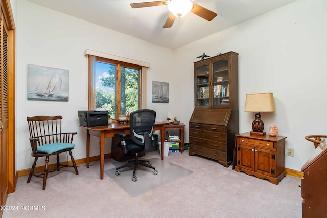 office area with light carpet, baseboards, and ceiling fan