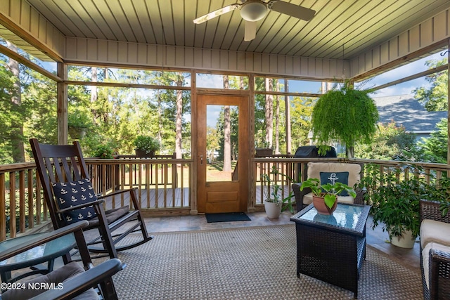 sunroom / solarium with ceiling fan and wood ceiling