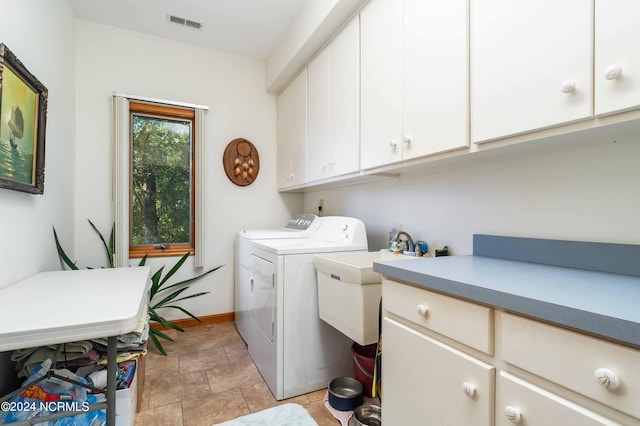 laundry room with stone finish flooring, baseboards, independent washer and dryer, visible vents, and cabinet space