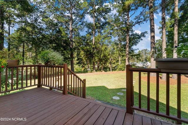 wooden terrace featuring a yard