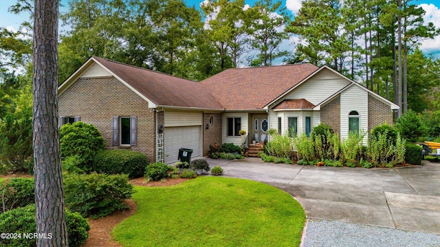 view of front of house with driveway, an attached garage, brick siding, and a front yard