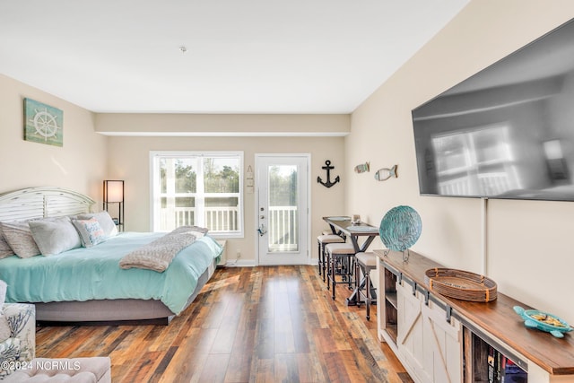 bedroom with access to exterior and hardwood / wood-style floors