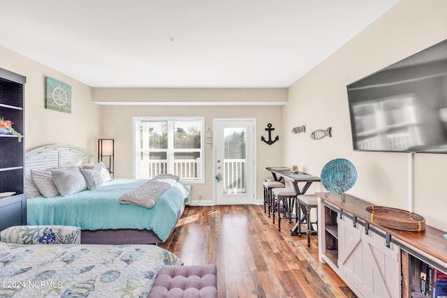 bedroom with hardwood / wood-style flooring and access to exterior