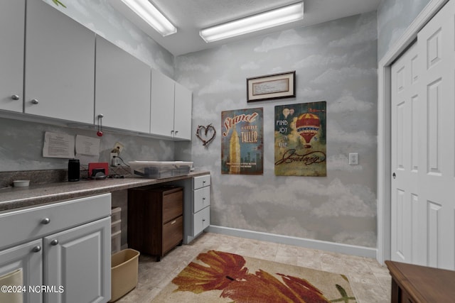 kitchen with gray cabinets and light tile patterned floors