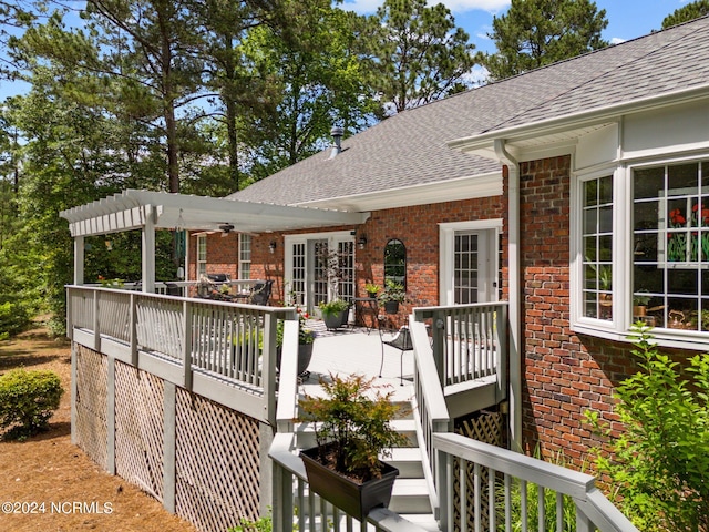 wooden deck featuring french doors and a pergola