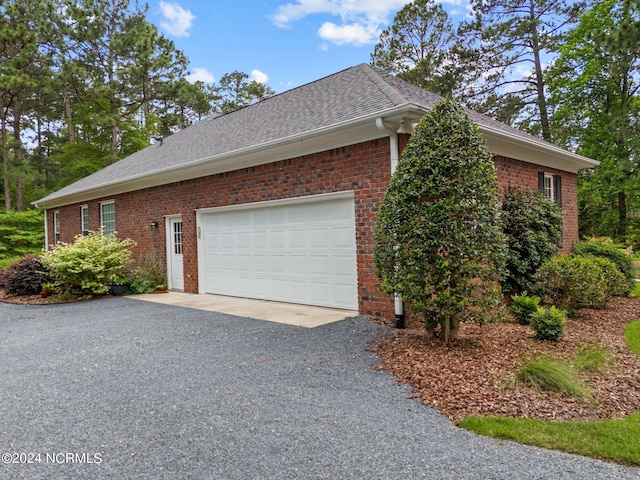 view of side of home featuring a garage