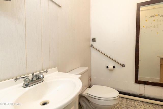 half bathroom featuring a sink and toilet