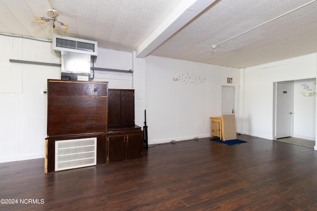 unfurnished living room featuring visible vents, baseboards, and wood finished floors