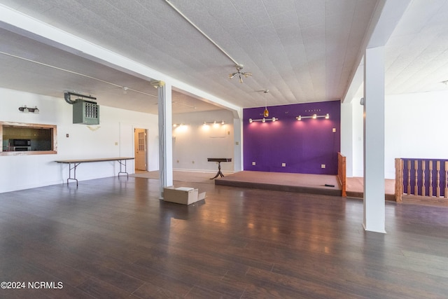 interior space featuring decorative columns and wood finished floors