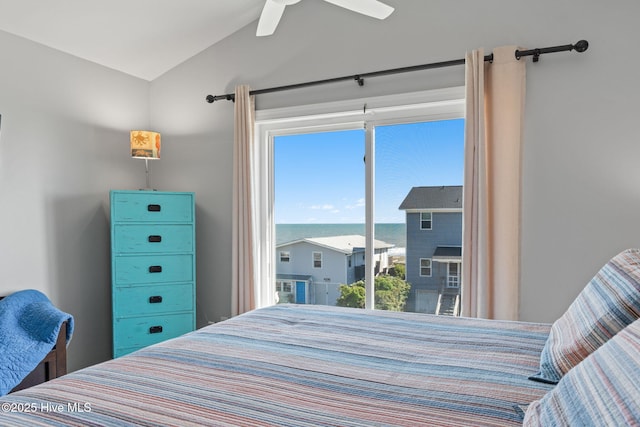 bedroom featuring ceiling fan, vaulted ceiling, and a water view