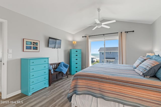 bedroom featuring baseboards, vaulted ceiling, wood finished floors, and a ceiling fan