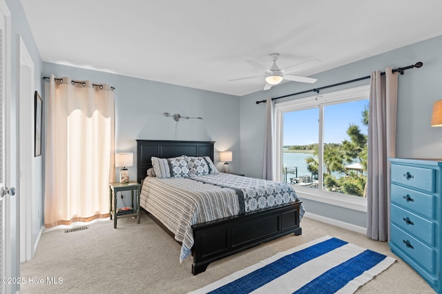 bedroom featuring baseboards, a ceiling fan, visible vents, and light colored carpet