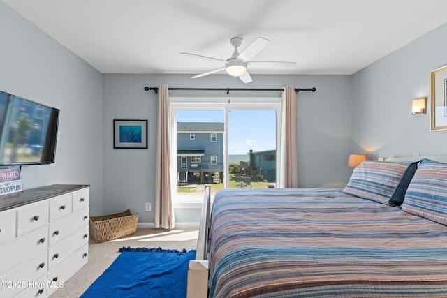 carpeted bedroom with a ceiling fan and baseboards