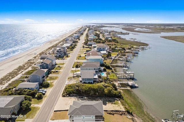 aerial view featuring a residential view, a view of the beach, and a water view