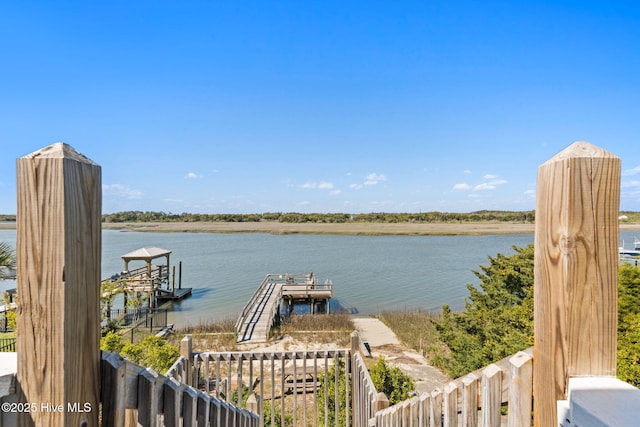 exterior space featuring a water view and fence