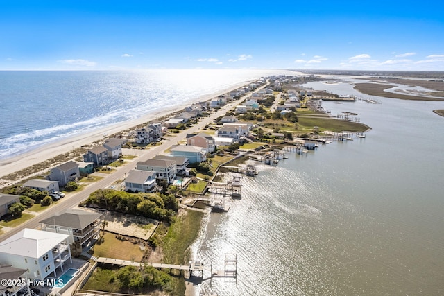 bird's eye view featuring a view of the beach and a water view