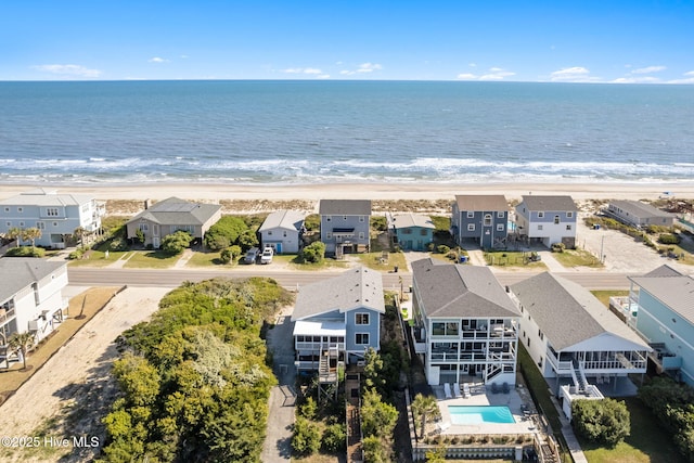 aerial view featuring a residential view, a view of the beach, and a water view